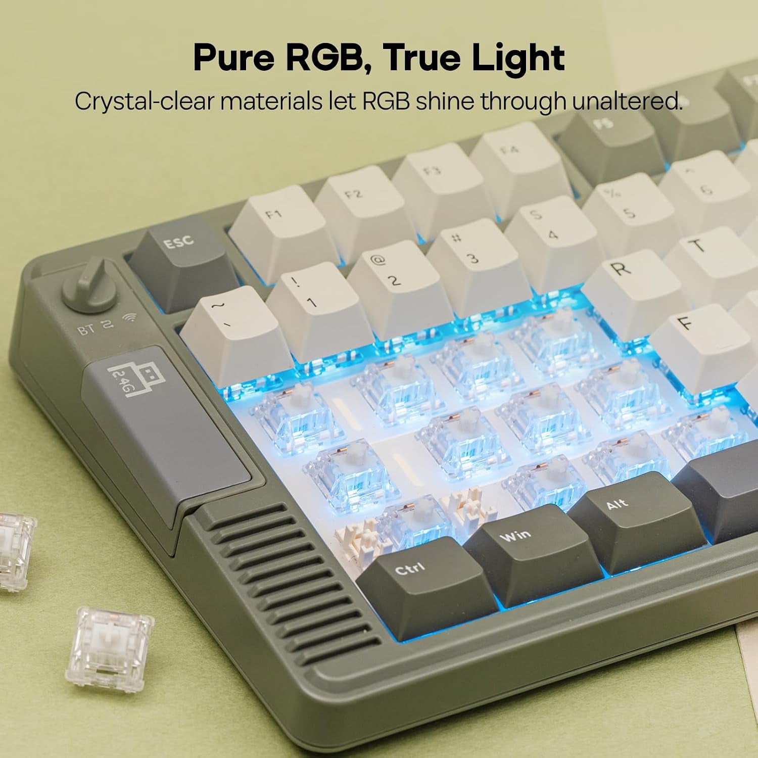 Close-up of a mechanical keyboard with white and gray keycaps partially removed, revealing crystal-clear switches glowing with blue RGB backlighting