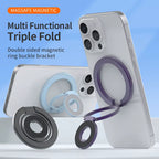 MagSafe magnetic ring grip and kickstand shown in three color variants — black, blue, and purple — with purple variant attached to back of silver iPhone 16 Pro used as a kickstand on a white surface, and text reading MAGSAFE MAGNETIC, Multi Functional Triple Fold, Double sided magnetic ring buckle bracket on light blue background