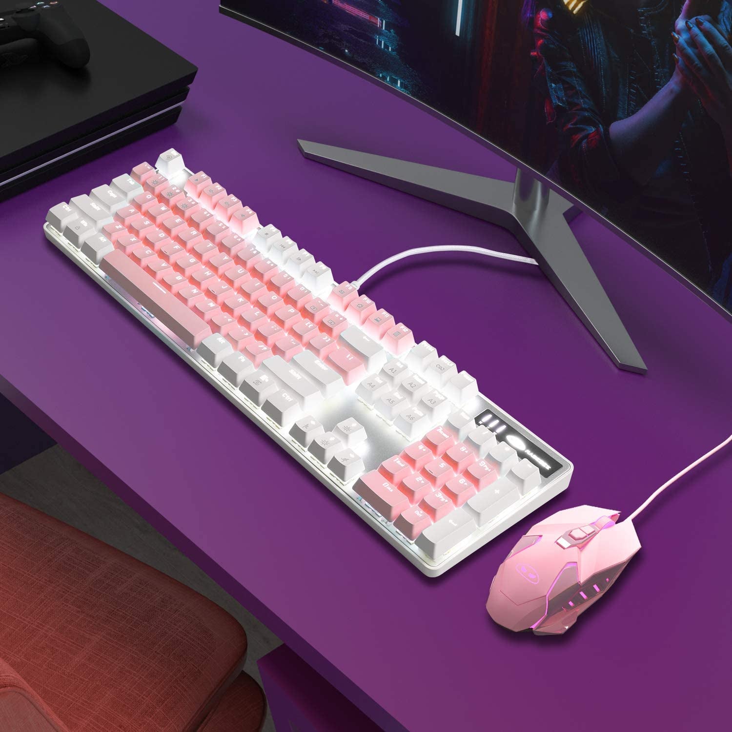 Pink and white keyboard and mouse set on a purple desk with a computer monitor in the background