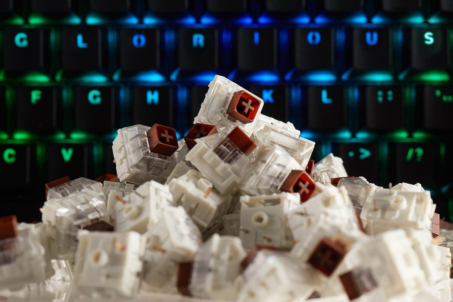 Pile of Kailh Box Brown Mechanical Keyboard Switches with mechanical keyboard in background