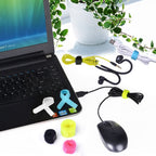 Laptop with mouse cable and audio cable being organized by cable ties on a white floor