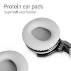 Close-up of two white COWIN E7 protein leather ear cushions removed from the headphones on a white background, showing the soft oval mesh interior and flexible foam padding, with bold black text reading "Protein ear pads — Supersoft very flexible"

