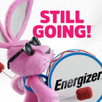 Energizer Bunny mascot in pink fur with black sunglasses playing a white and blue bass drum with Energizer logo, with text reading Still Going! on white background