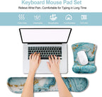 Person using laptop with marble design mouse pad and wrist rest on a white background