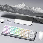 White side-print PBT keycaps on a TKL mechanical keyboard in a minimal desk setup with monitor, mouse, and earbuds