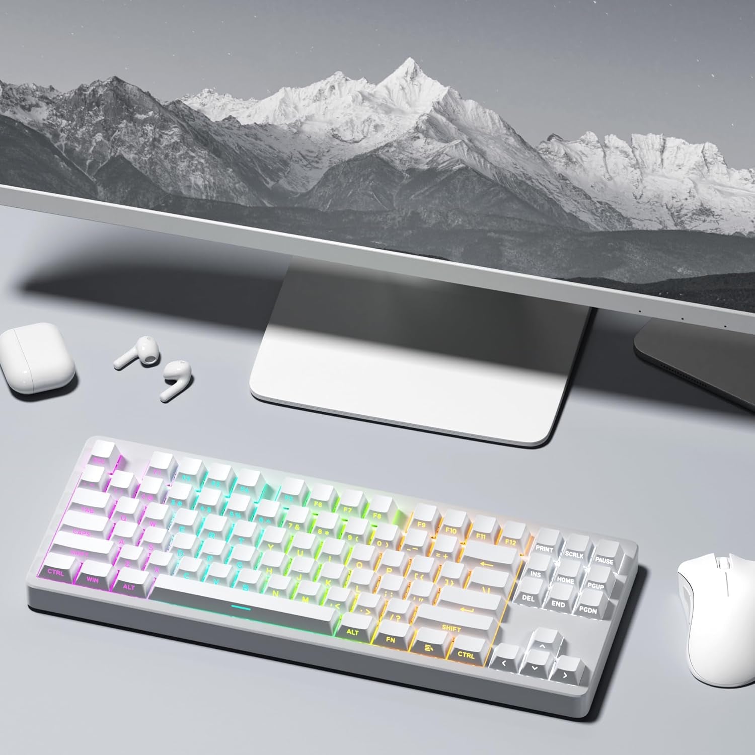 White side-print PBT keycaps on a TKL mechanical keyboard in a minimal desk setup with monitor, mouse, and earbuds