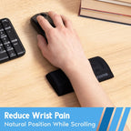 Hand using mouse with i-Rocks memory foam mouse wrist rest on wooden desk next to full size keyboard and book stack
