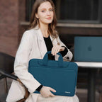 Woman in a white blazer sitting outdoors at a cafe holding a teal MOSISO laptop bag by its top handles with a MacBook visible on the table behind her
