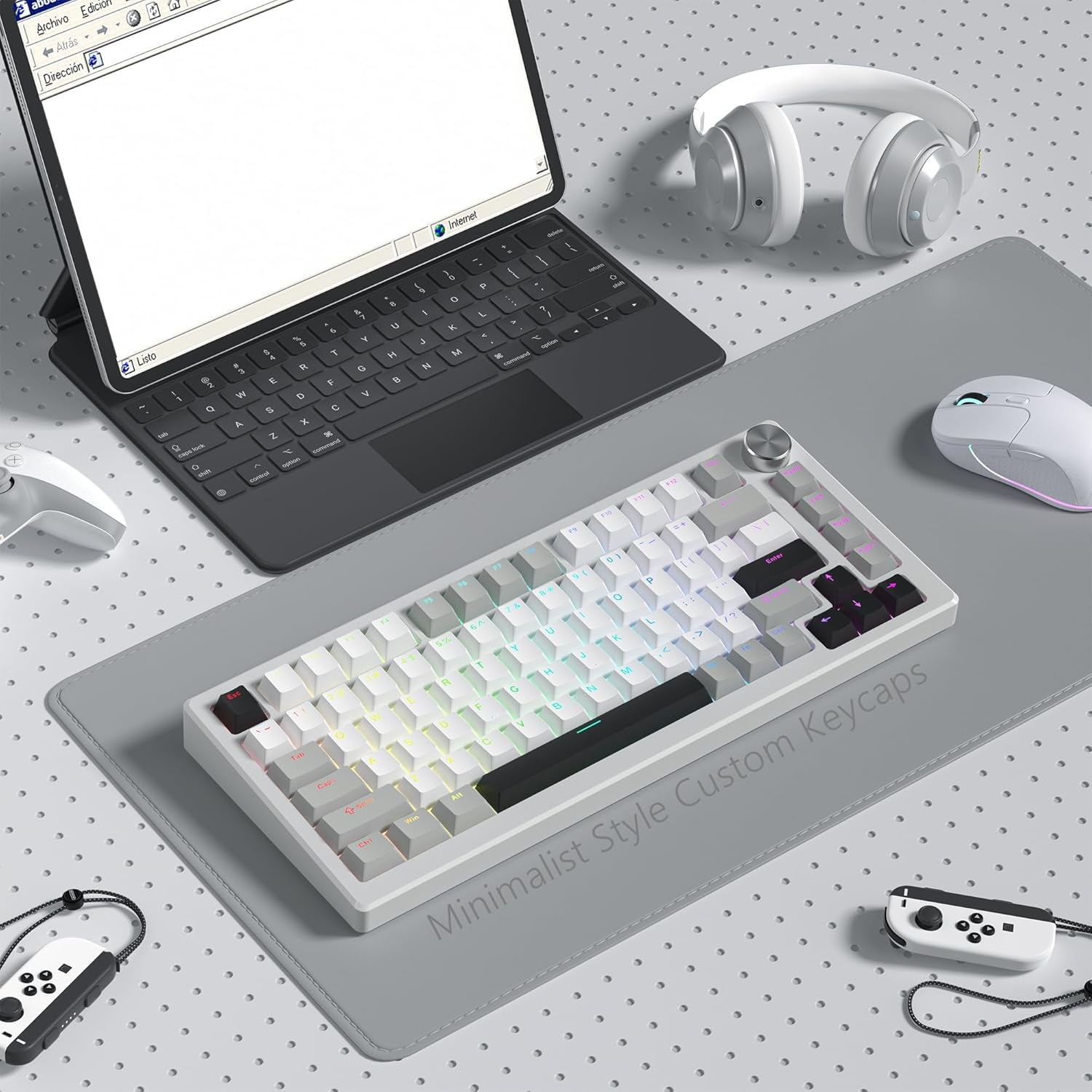 Minimalist desk setup featuring a compact mechanical keyboard with creamy white and gray shine through PBT keycaps, alongside a mouse, headphones, and laptop