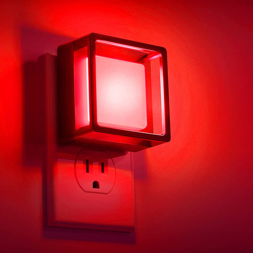 DORESshop automatic night light plug in with red LED glow casting warm light on wall